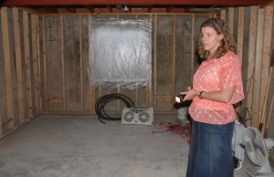 Jessicca in her ruined basement - the water crashed through the window.